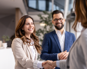 Two people shaking hands after completing a deal