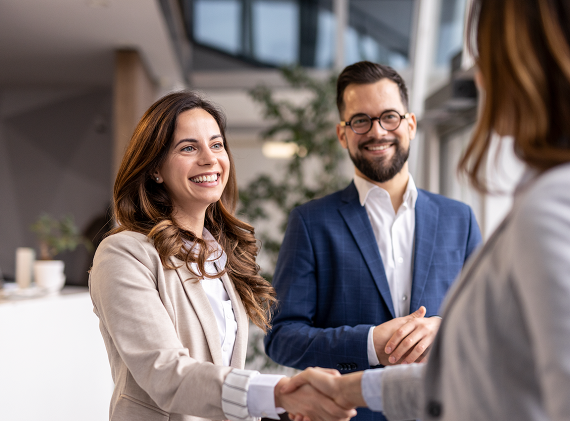 Two people shaking hands after completing a deal