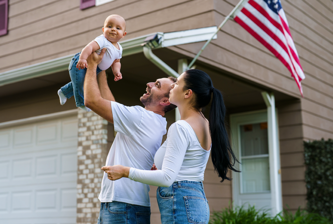 Couple holding a baby and American Flag