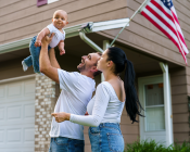 Couple holding a baby and American Flag