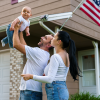 Couple holding a baby and American Flag